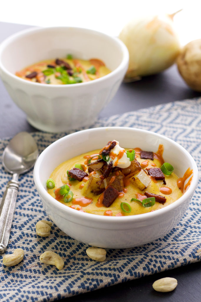 bowls of vegan creamy potato soup recipe with cashews and carrot