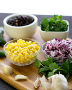 cut ingredients for stuffed sweet potatoes with black beans and kale