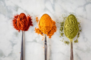 Spoons of herbs representing what's in a good vegan multivitamin