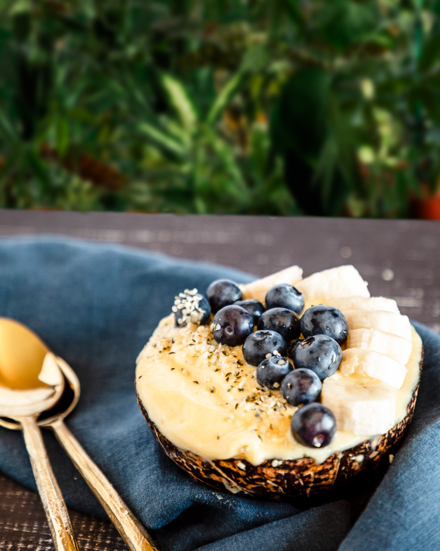 Copycat dole whip smoothie bowl in front of greenery