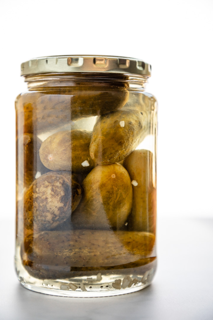 Pickle jar in front of white background