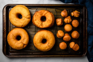 Fried vegan doughnuts on drip tray