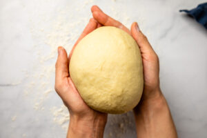 Shaping doughnut dough into ball